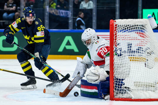 Jacob De La Rose of Sweden and goaltender Damian Clara of