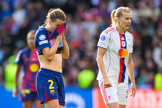 Irene Paredes of Barcelona looks dejected and Ada Hegerberg
