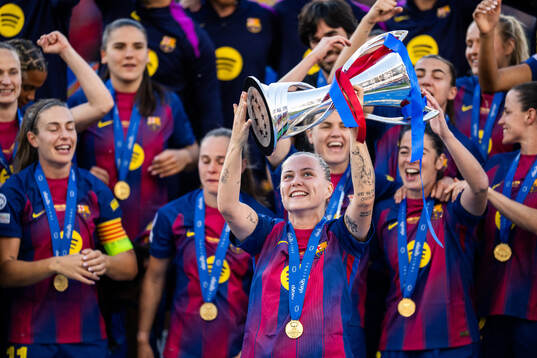 Claudia Pina of Barcelona celebrates with the trophy