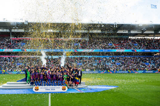 Players of Barcelona celebrate with the trophy