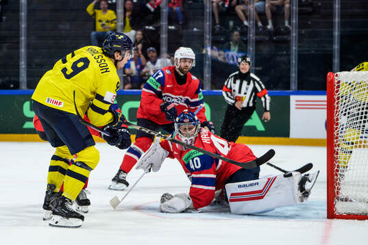 Linus Karlsson of Sweden and goaltender Henrik Haukeland of