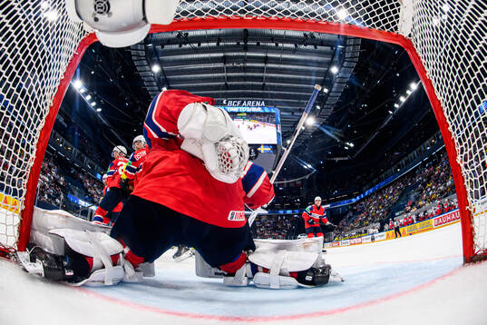 goaltender Henrik Haukeland of Norway saves a puck behind