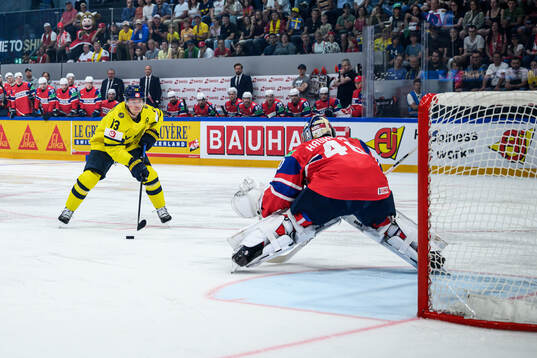 Lucas Raymond of Sweden and goaltender Henrik Haukeland of