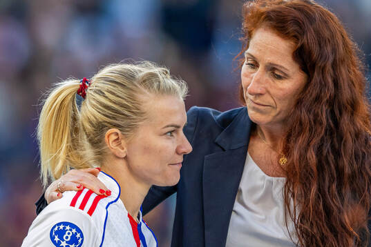 Ada Hegerberg of Lyon and Lise Klaveness, president of the