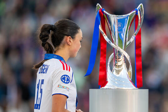 Ingrid Engen of Lyon looks dejected as she walks past the