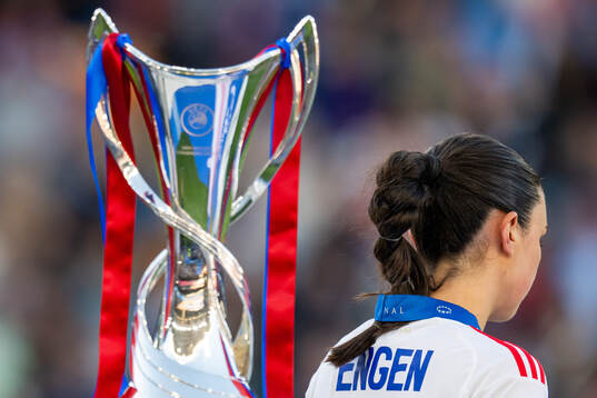 Ingrid Engen of Lyon looks dejected as she walks past the