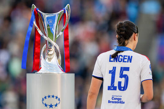 Ingrid Engen of Lyon looks dejected as she walks past the
