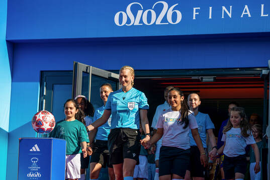 Referee Tess Olofsson enters the pitch