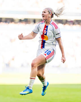 Lindsey Heaps of Lyon celebrates scoring a goal later being