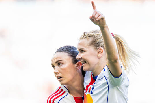 Ingrid Engen and Ada Hegerberg of Lyon celebrate a goal