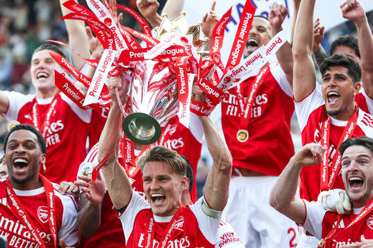 Martin Ødegaard of Arsenal celebrates with the trophy for