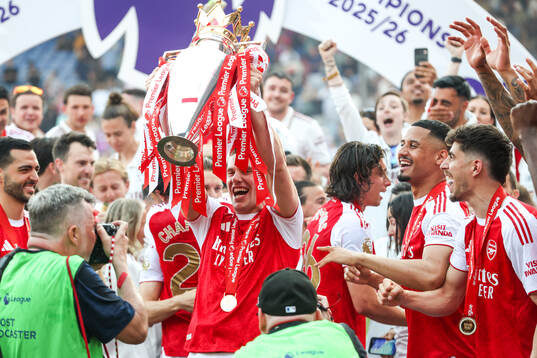Martin Ødegaard of Arsenal celebrates with the trophy for