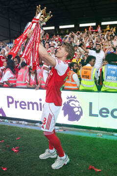 Martin Ødegaard of Arsenal celebrates with the trophy for