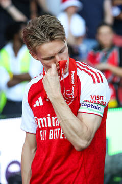 Martin Ødegaard of Arsenal celebrates with the trophy for