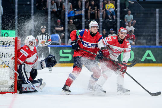 Goaltender Nicolaj Henriksen and Nick Olesen of Denmark and