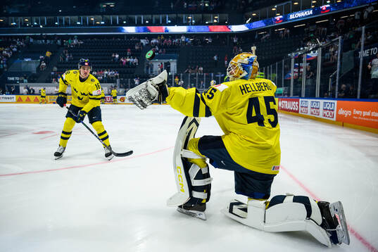 Anton Frondell and goaltender Magnus Hellberg of Sweden