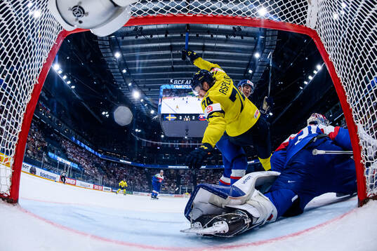 Rasmus Asplund of Sweden and goaltender Samuel Hlavaj of