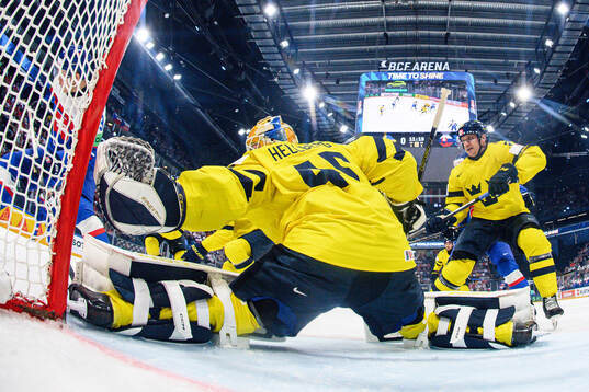 goaltender Magnus Hellberg and Jakob Silfverberg of Sweden