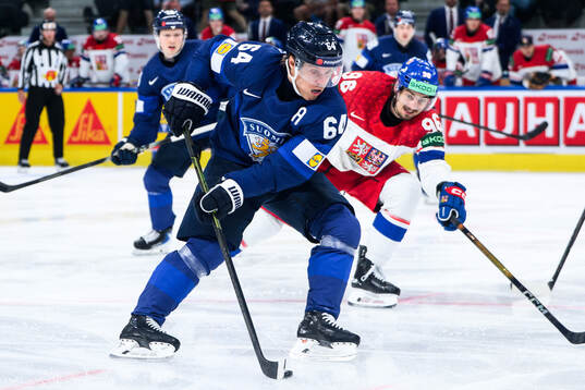 Mikael Granlund of Finland and David Tomasek of Czech