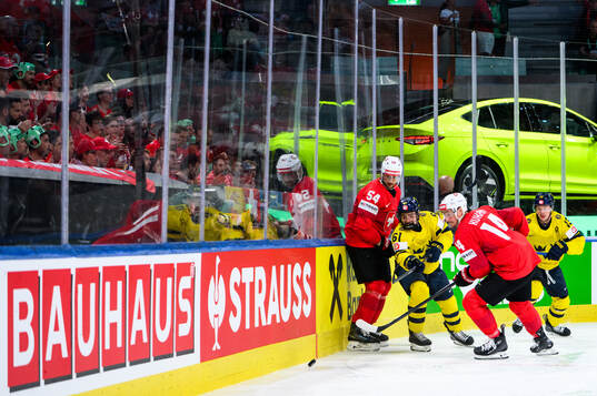 Christian Marti and Dean Kukan of Switzerland compete for