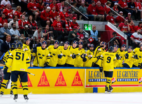 Linus Karlsson of Sweden celebrates with team m ates