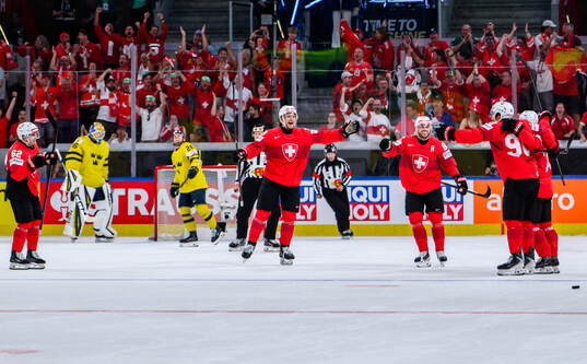 Roman Josi of Switzerland celebrates with team mates