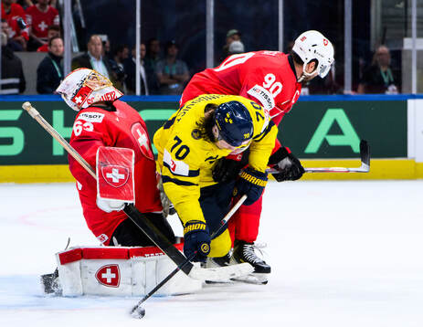 Goaltender Leonardo Genoni and Roman Josi of Switzerland