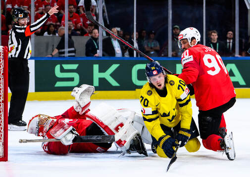 Goaltender Leonardo Genoni and Roman Josi of Switzerland