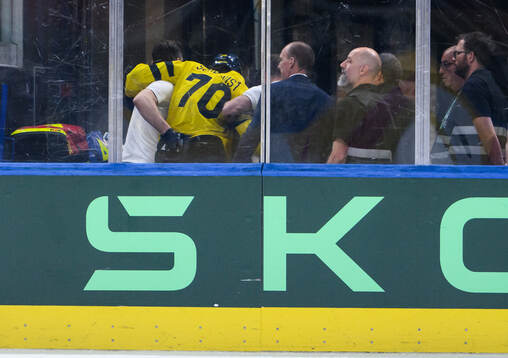 Oscar Sundqvist of Sweden leaves the ice due to injury