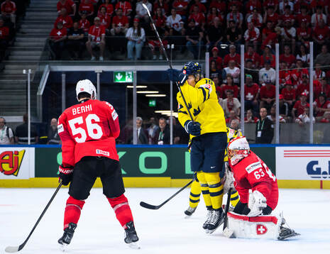 Jack Berglund of Sweden and goaltender Leonardo Genoni of