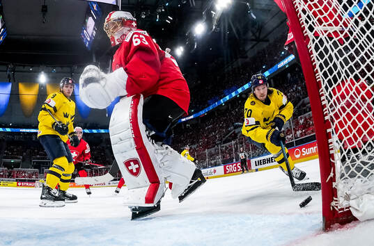 Leonardo Genoni of Switzerland concedes a goal from Oscar
