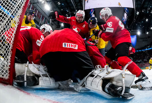 Jack Berglund of Sweden competes for the puck with of