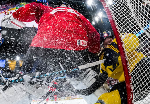 Leonardo Genoni of Switzerland concedes a goal from Oscar