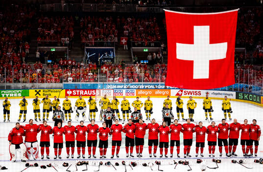 Players of Sweden look dejected as players of Switzerland