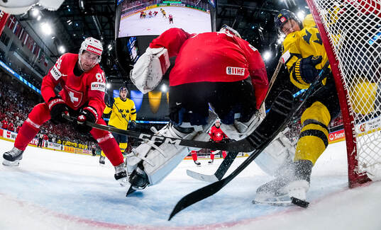 Leonardo Genoni of Switzerland concedes a goal from Oscar