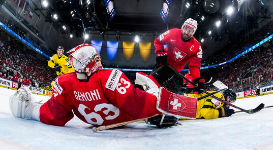 Goaltender Leonardo Genoni and Roman Josi of Switzerland