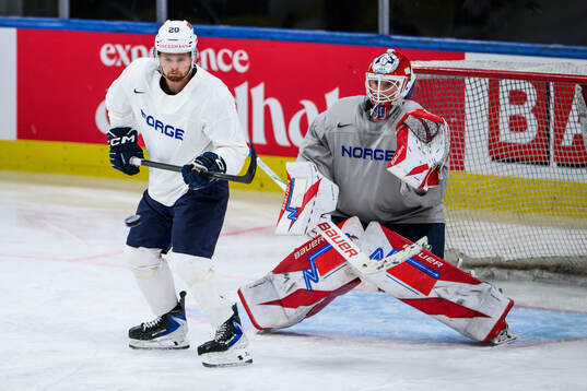 Emilio Pettersen and goaltender Tobias Normann of Norway at