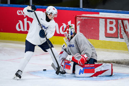 Noah Steen and goaltender Tobias Normann of Norway at a