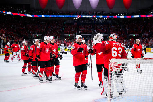 Damien Riat and Leonardo Genoni of Switzerland celebrates