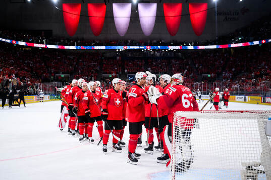 Ken Jager and Leonardo Genoni of Switzerland celebrate