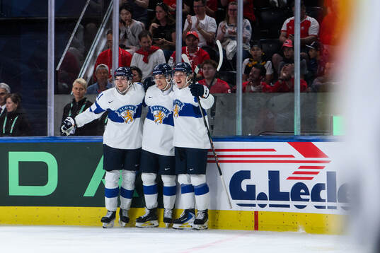 Patrik Puistola of Finland celebrates with teammates