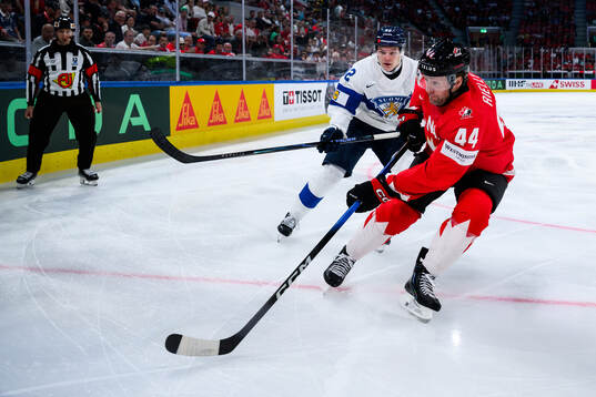 Lenni Hämeenaho of Finland and Morgan Rielly of Canada
