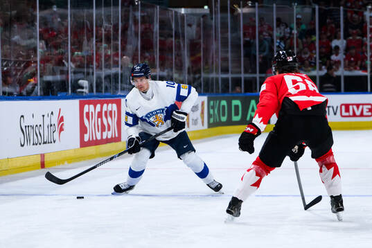 Henri Jokiharju of Finland and Emmitt Finnie of Canada