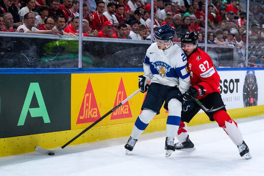 Patrik Puistola of Finland and Sidney Crosby of Canada