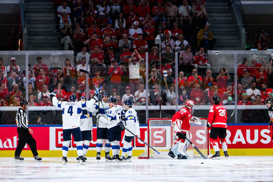 Alexander Barkov and Mikael Granlund of Finland celebrates