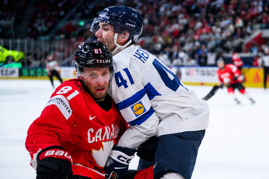 Dylan Holloway of Canada and Ville Heinola of Finland