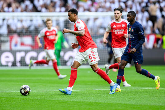 Gabriel of Arsenal and Ousmane Dembele of Paris