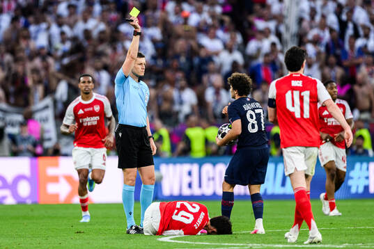 Referee Daniel Siebert and Joao Neves of Paris Saint-Germain