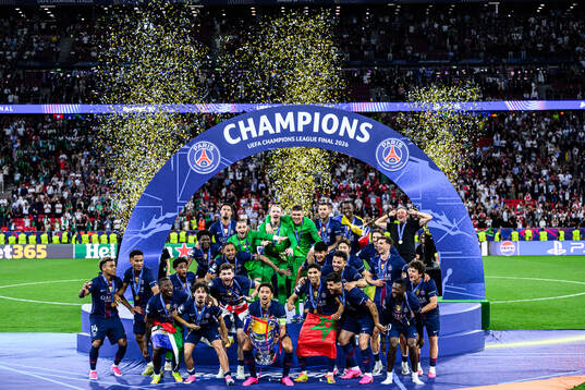 Players of Paris Saint-Germain celebrate with the trophy