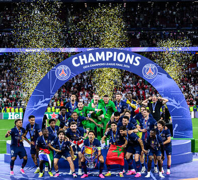 Players of Paris Saint-Germain celebrate with the trophy